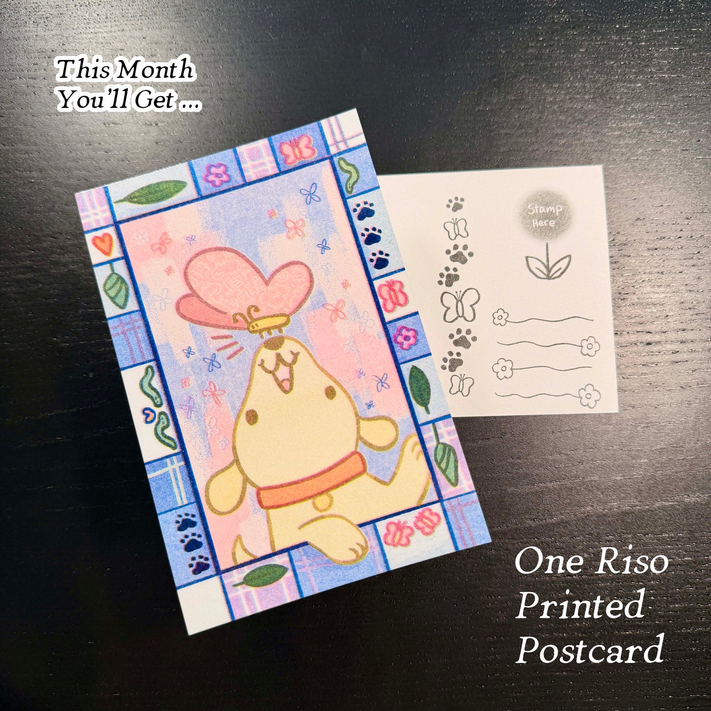 Riso printed postcard with a cartoon dog design on a dark surface