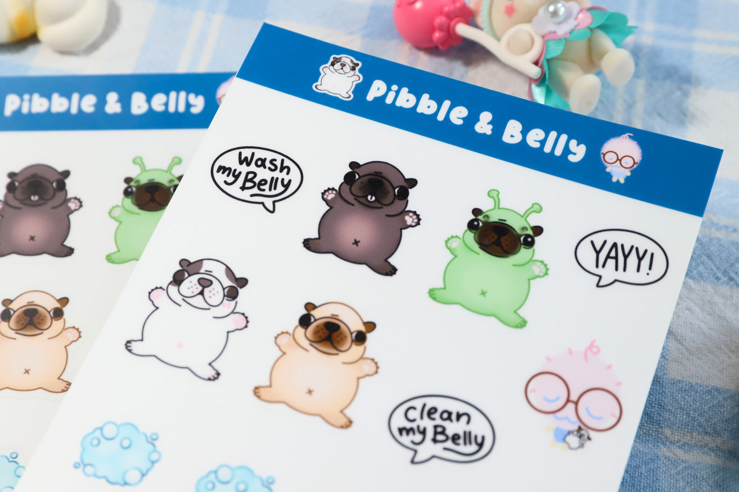 Sheet of Pibble & Belly stickers with cartoon pug bull dog puppy on a blue background.